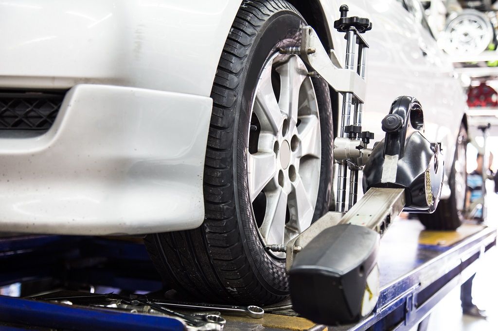 an image of car getting tyres aligned 